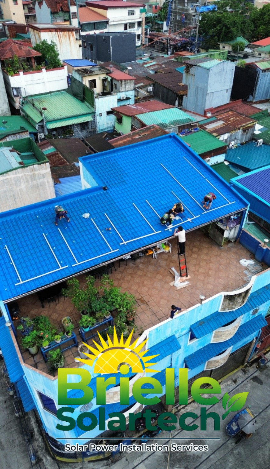 Aerial view of mounting rails being installed on a blue roof