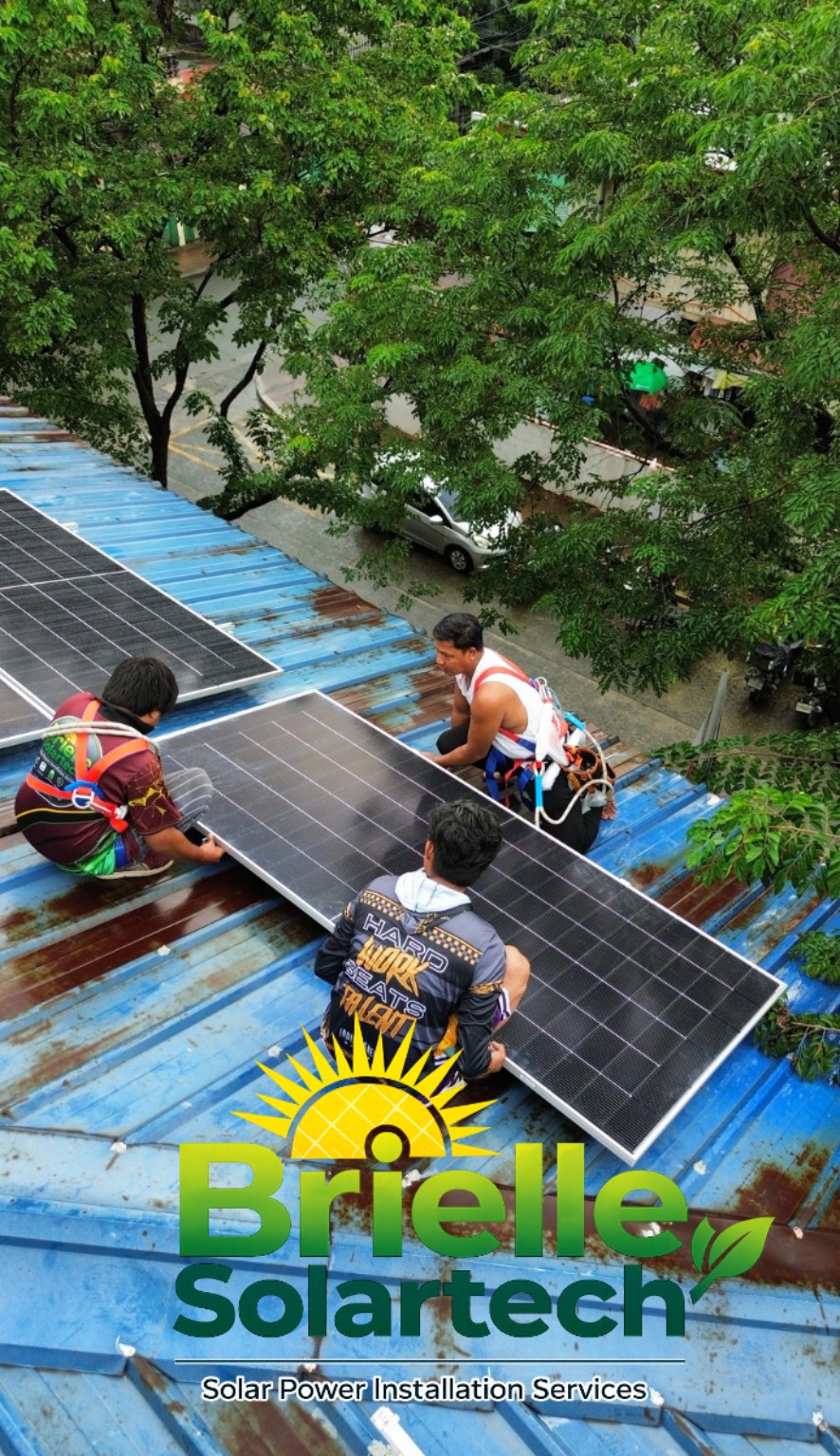 Brielle Solartech installers positioning a solar panel on a rooftop